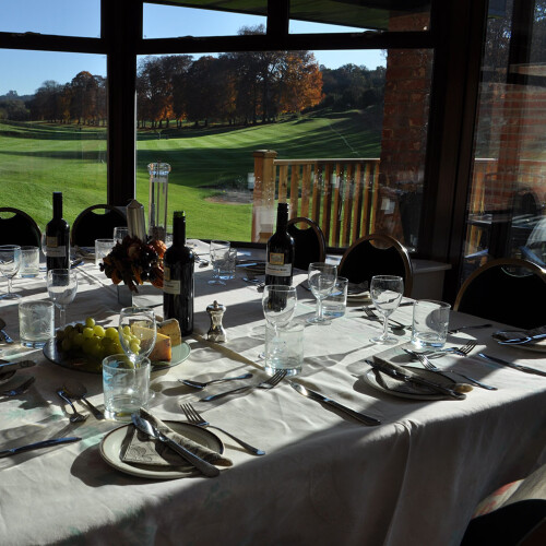 Dining area overlooking decking with scenic greenery